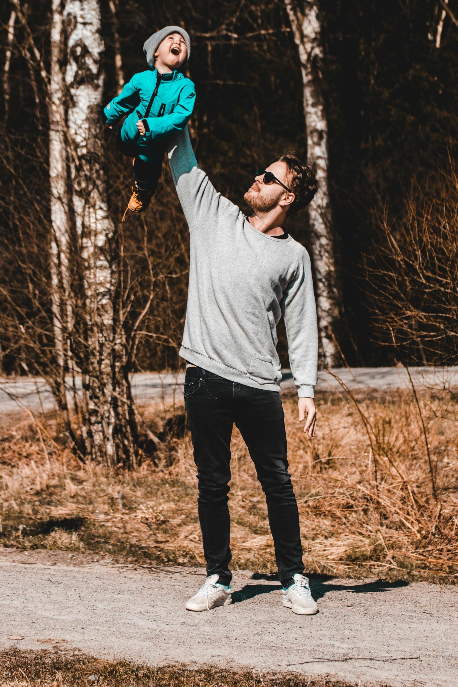 father holding his child in the air playfully