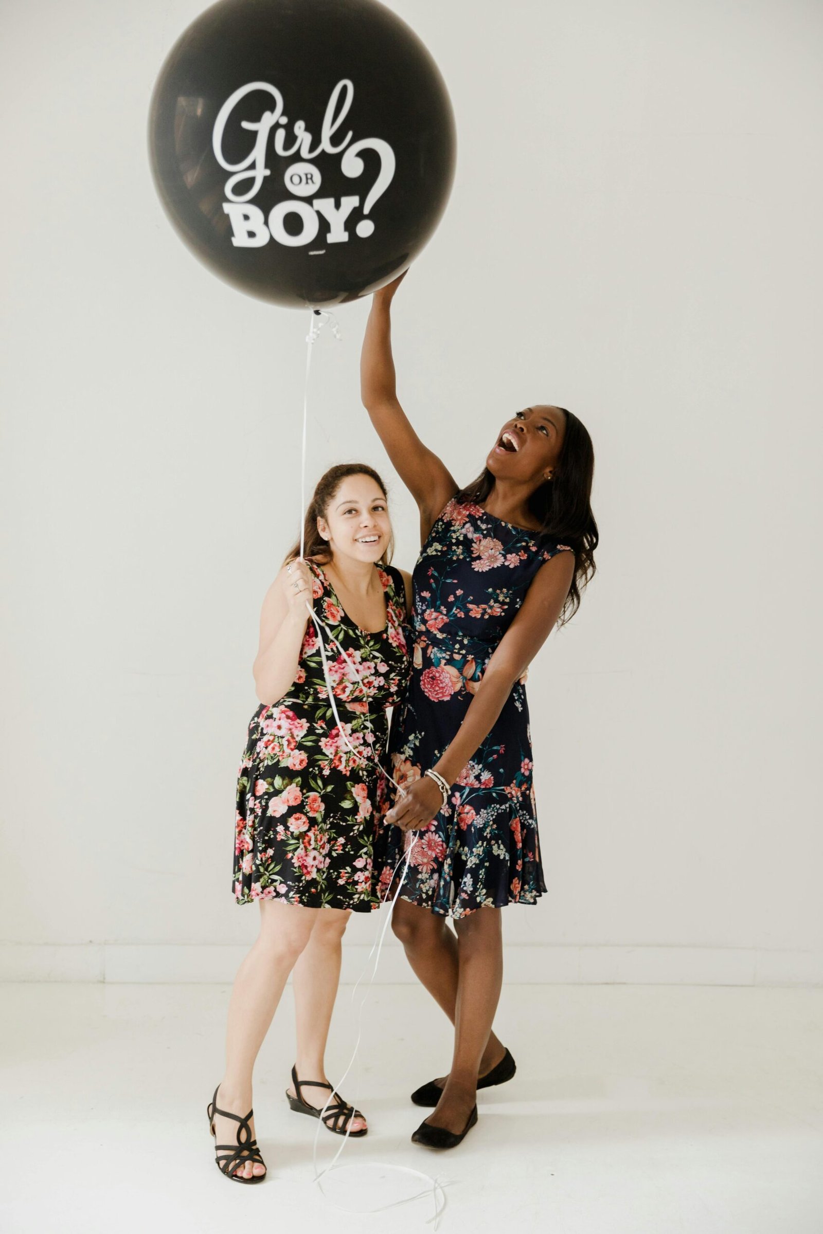 2 young girls holding balloon